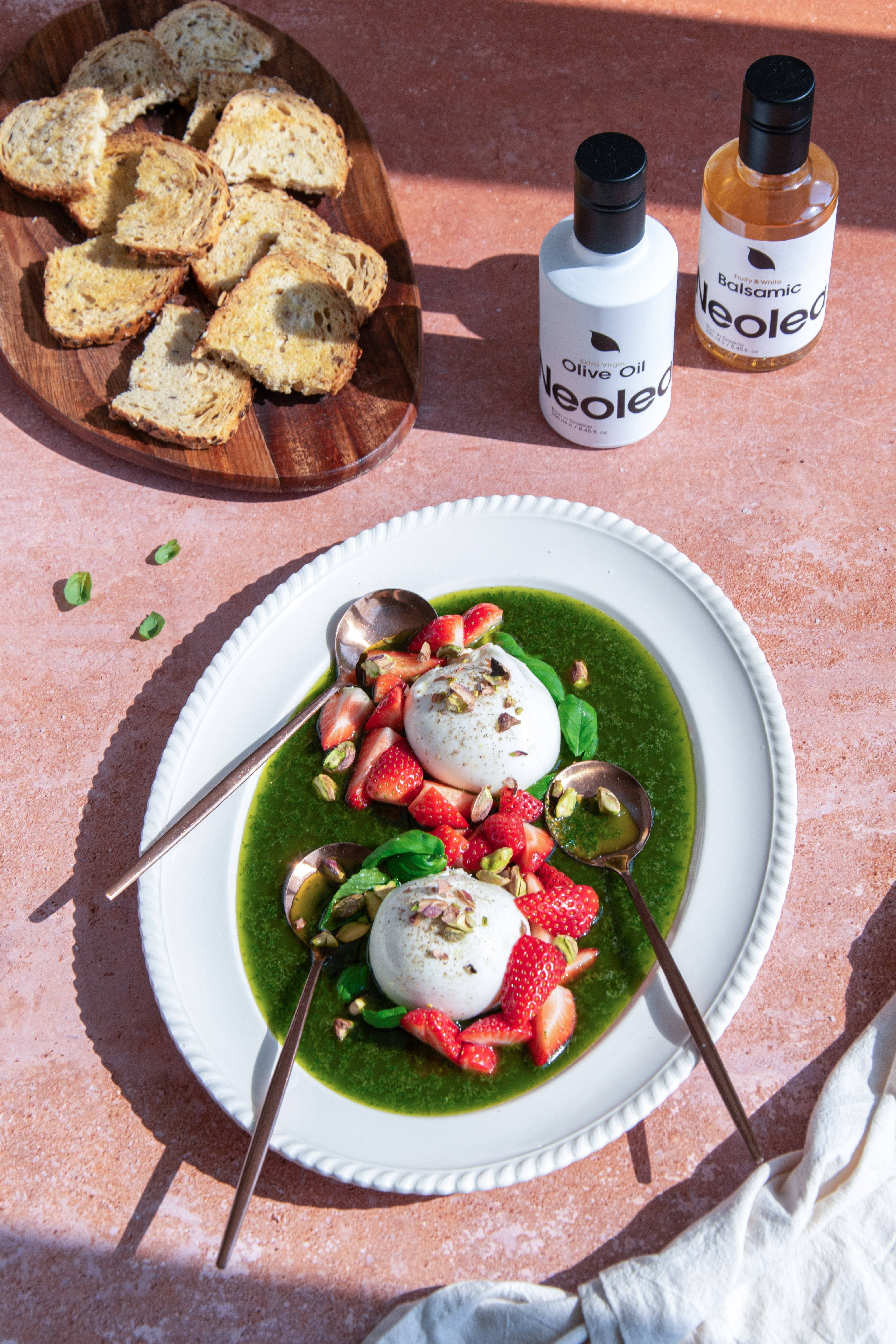 Burrata with Fresh Basil Sauce, Sweet Strawberries, and Pistachio Crumble